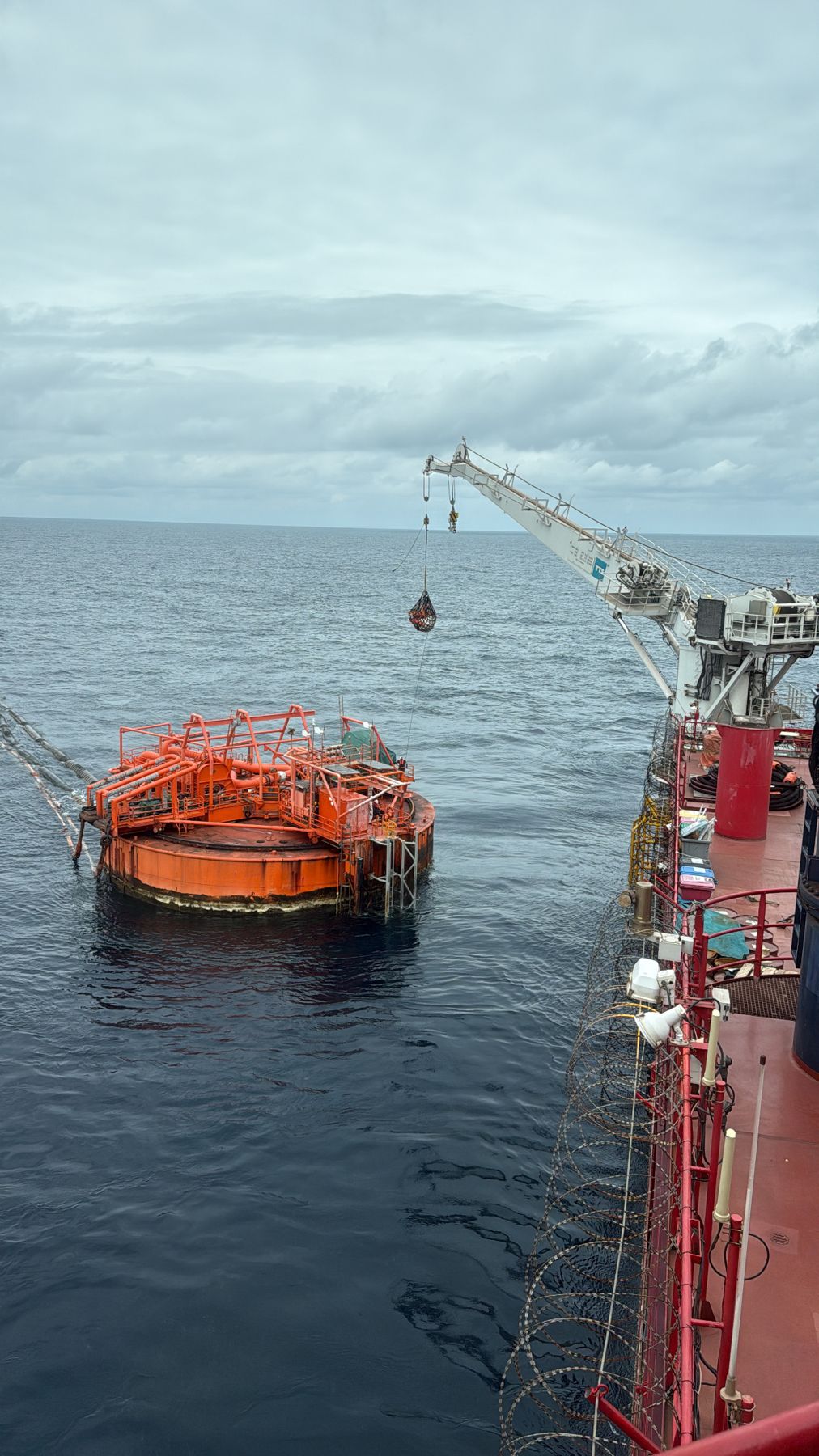 CALM buoy offshore with support vessel alongside